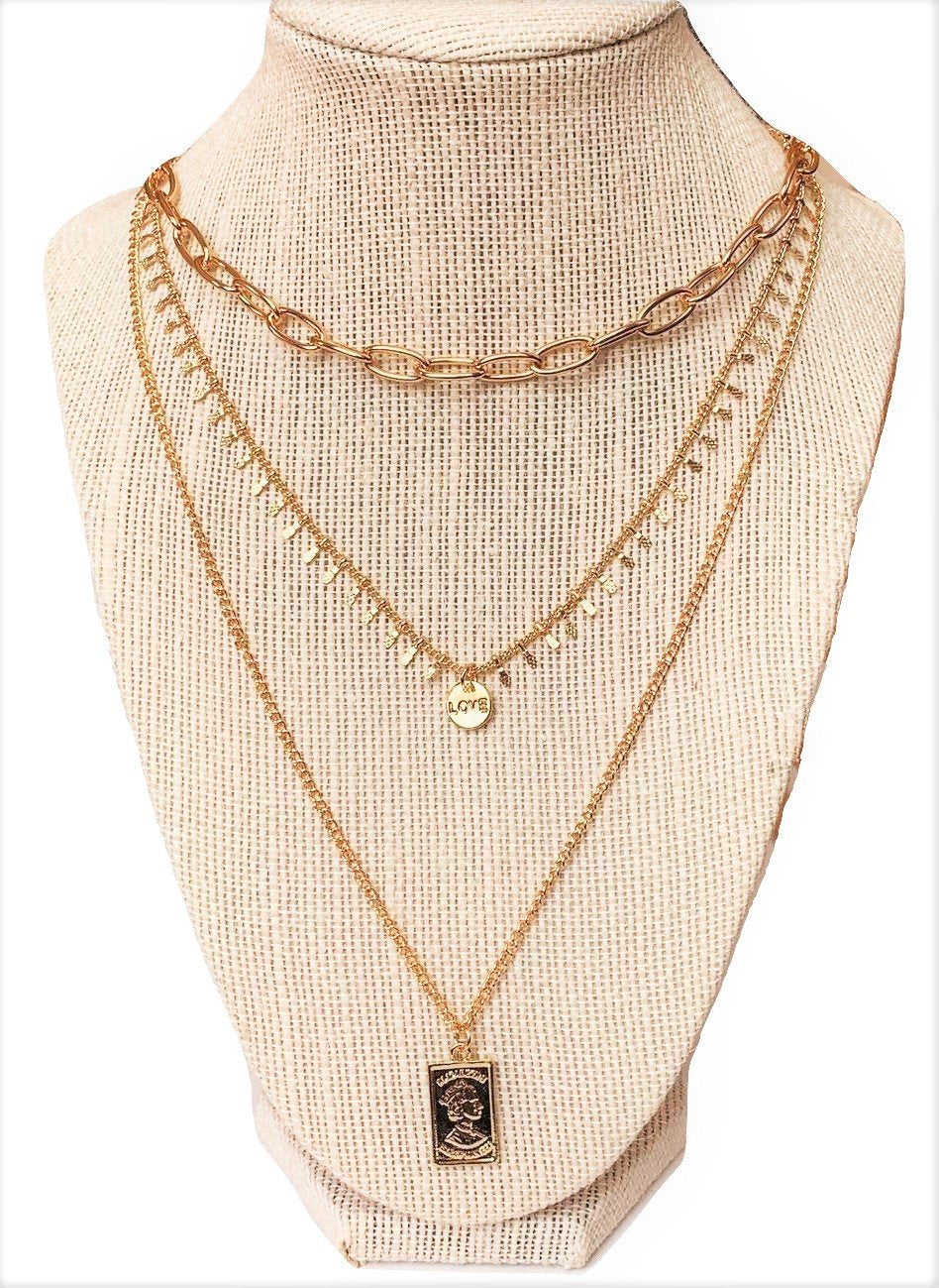 Three Layer Necklace w/ Rectangle Pendant hanging on a manakin