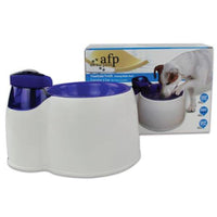 Thumbnail for A 2l interactive fresh water filter bowl shown in blue and white with a brown and white dog shown drinking from it